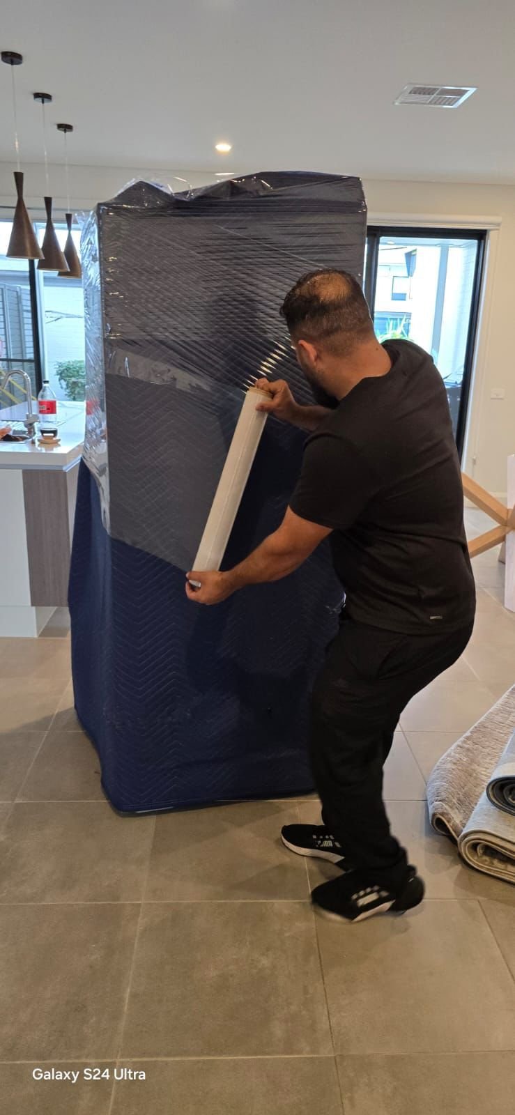 Bowral removalist carefully wrapping furniture for safe transport